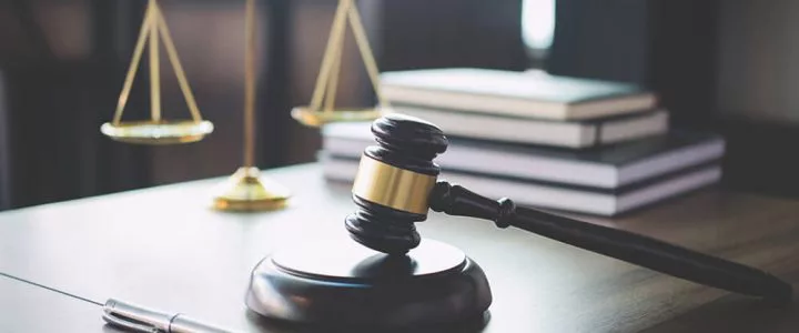 Gavel and scale representing professional licensure defense and disciplinary proceedings.
