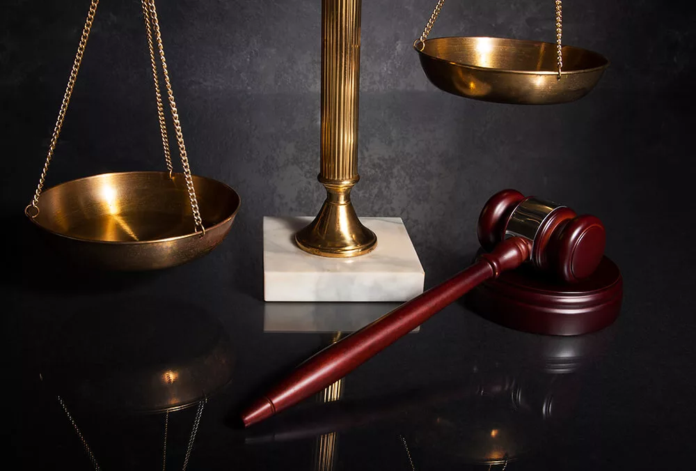 Gavel and brass scale representing white collar criminal defense
